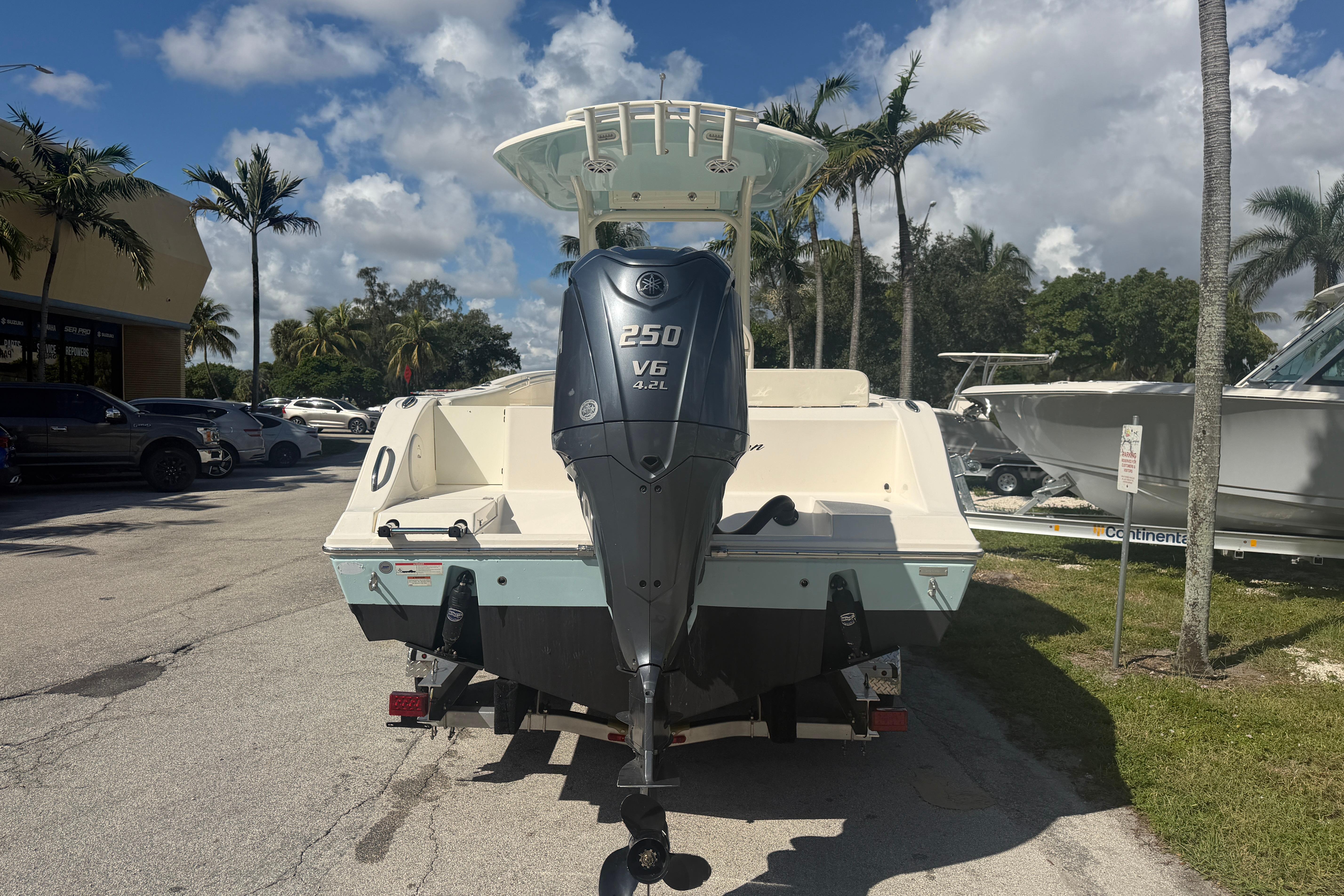 2021 Cobia 237 Center Console boat with Yamaha 250 V6 engine, parked outdoors.