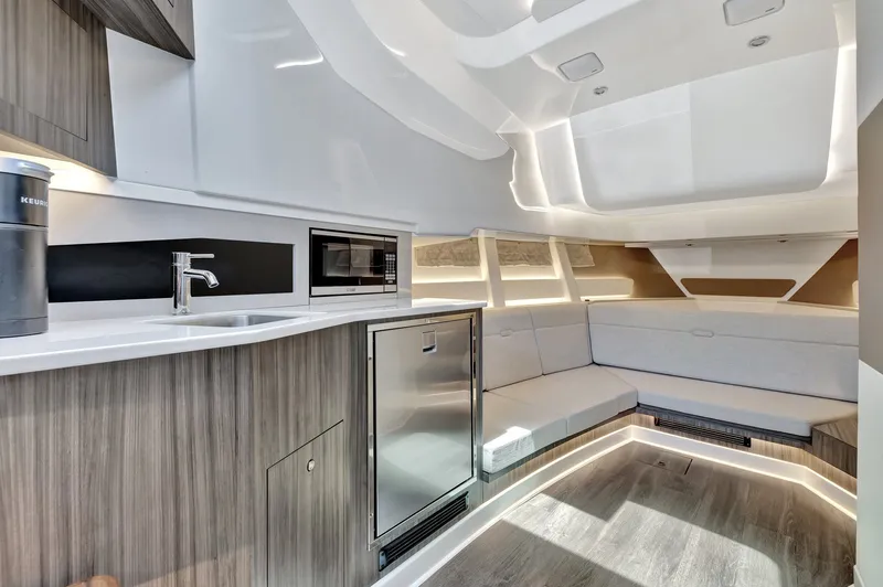  Yacht Photos Pics Luxurious interior of 2024 Sea Ray Sundancer 370 Outboard with modern kitchen and seating area.