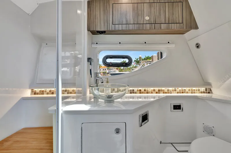  Yacht Photos Pics Luxurious bathroom interior of 2024 Sea Ray Sundancer 370 Outboard yacht, featuring modern fixtures.