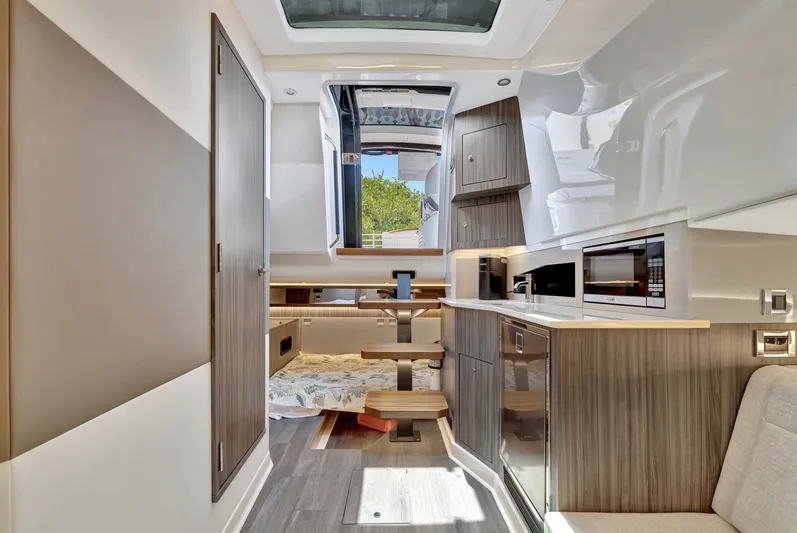  Yacht Photos Pics Luxurious interior of 2024 Sea Ray Sundancer 370 Outboard, featuring modern kitchen and cozy seating.