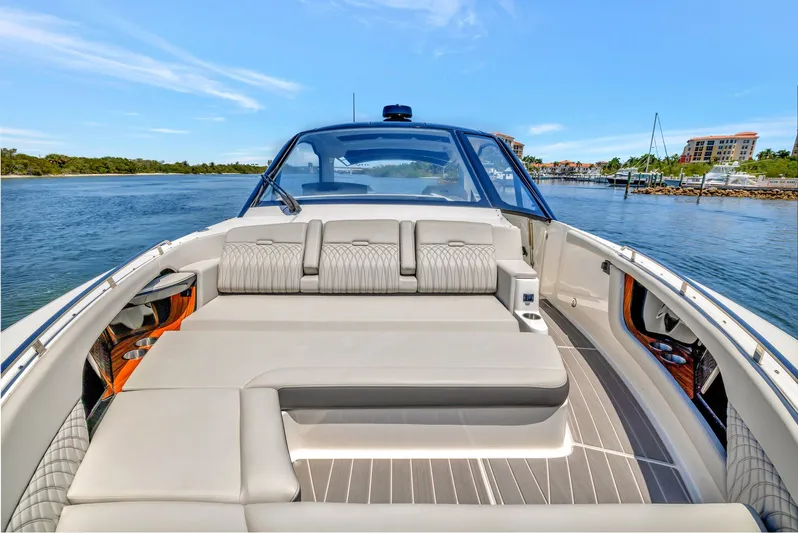  Yacht Photos Pics 2024 Sea Ray Sundancer 370 Outboard luxury boat interior with plush seating on calm water.