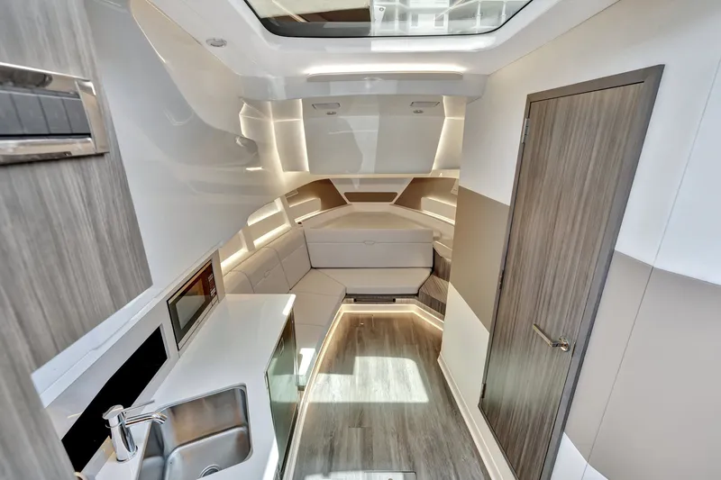  Yacht Photos Pics 2024 Sea Ray Sundancer 370 Outboard interior with modern design, kitchenette, and seating area.