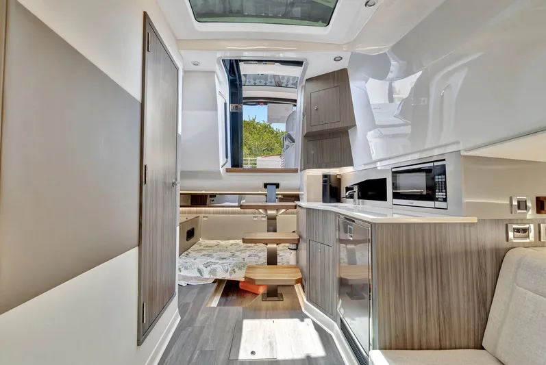  Yacht Photos Pics Luxurious interior of 2024 Sea Ray Sundancer 370 Outboard, featuring modern kitchen and cozy seating.