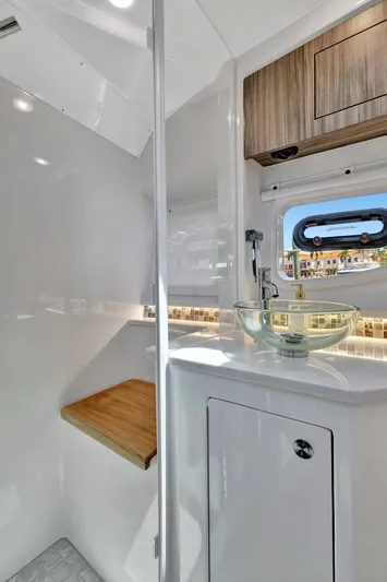  Yacht Photos Pics 2024 Sea Ray Sundancer 370 Outboard bathroom with modern sink and wooden accents.