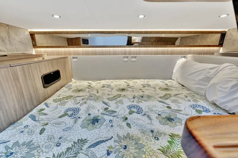  Yacht Photos Pics 2024 Sea Ray Sundancer 370 Outboard cabin interior with floral bedding and modern lighting.