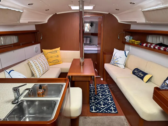 Bel Canto Yacht Photos Pics Interior of 2014 Beneteau 37 sailboat with cozy seating and nautical decor.