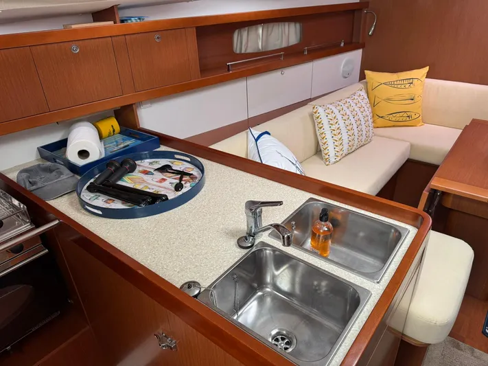 Bel Canto Yacht Photos Pics Interior of 2014 Beneteau 37 yacht, featuring a cozy galleyand seating area.