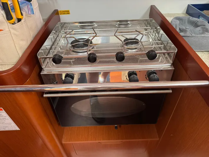 Bel Canto Yacht Photos Pics Stove and oven in 2014 Beneteau 37 yacht galley featuring stainless steel finish.