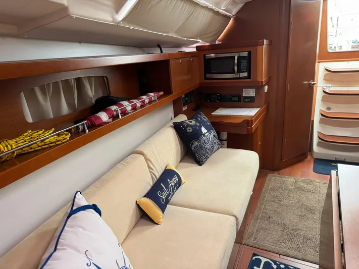 Bel Canto Yacht Photos Pics Interior of 2014 Beneteau 37 yacht with cozy seating, nautical decor, and modern amenities.