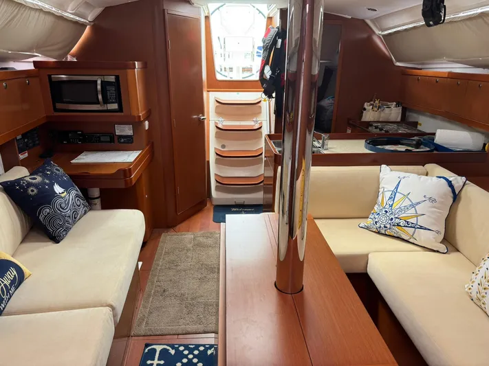 Bel Canto Yacht Photos Pics Interior of 2014 Beneteau 37 sailboat with cozy seating and nautical decor.