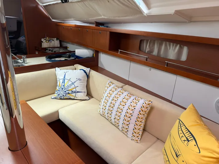 Bel Canto Yacht Photos Pics Interior of 2014 Beneteau 37 yacht with cozy seating and decorative pillows.
