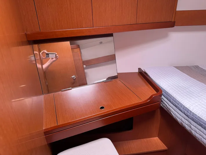 Bel Canto Yacht Photos Pics Interior of 2014 Beneteau 37 yacht with wooden desk and mirror in cabin.