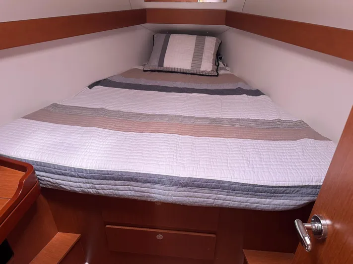 Bel Canto Yacht Photos Pics Cozy cabin interior of 2014 Beneteau 37 sailboat with striped bedding.