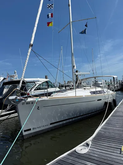 Bel Canto Yacht Photos Pics 2014 Beneteau 37 sailboat docked at marina with flags on mast.