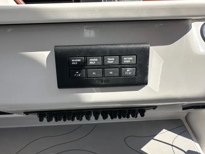  Yacht Photos Pics Control panel on a 2026 Regal 38 SAV boat with Yamaha navigation buttons.