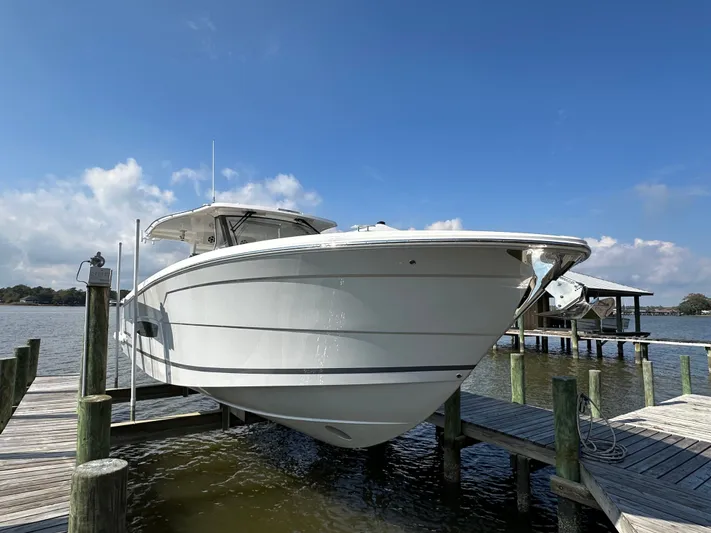  Yacht Photos Pics 2026 Regal 38 SAV boat docked on a sunny day, showcasing sleek design.
