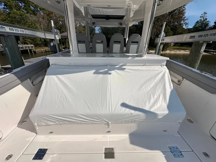  Yacht Photos Pics 2026 Regal 38 SAV boat interior with covered seating and helm station.