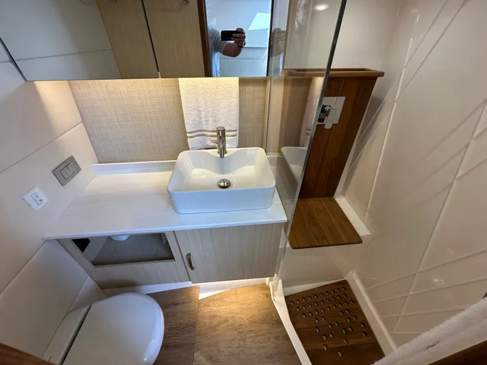  Yacht Photos Pics Modern bathroom in 2026 Regal 38 SAV yacht with sleek sink and wooden accents.