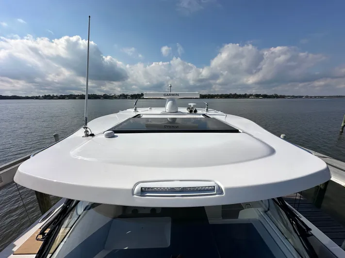  Yacht Photos Pics 2026 Regal 38 SAV yacht docked, showcasing sleek design and advanced Garmin navigation system.