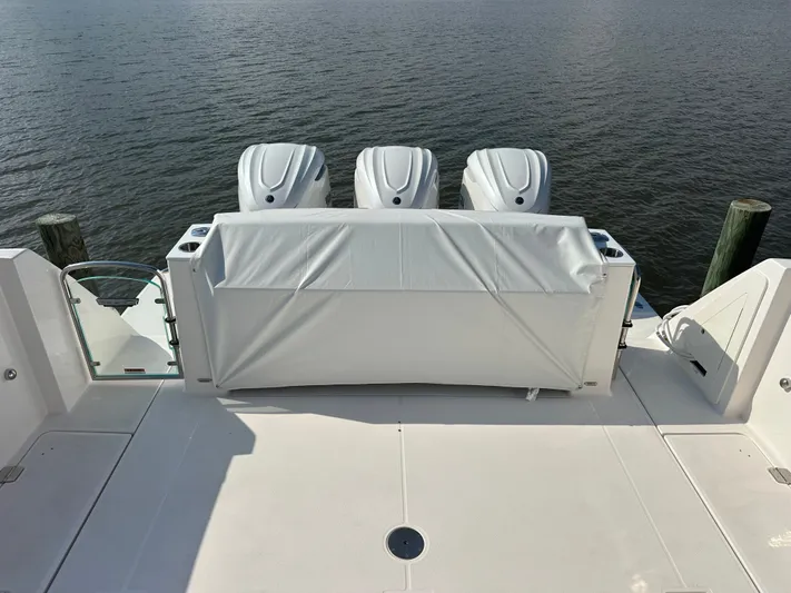  Yacht Photos Pics 2026 Regal 38 SAV boat with triple outboard engines on calm water.