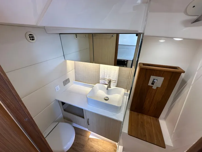  Yacht Photos Pics Modern bathroom in 2026 Regal 38 SAV yacht with sink, toilet, and wood accents.