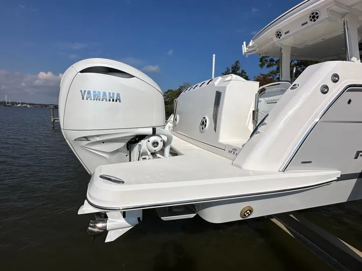  Yacht Photos Pics 2026 Regal 38 SAV boat with Yamaha outboard engine on a sunny day.
