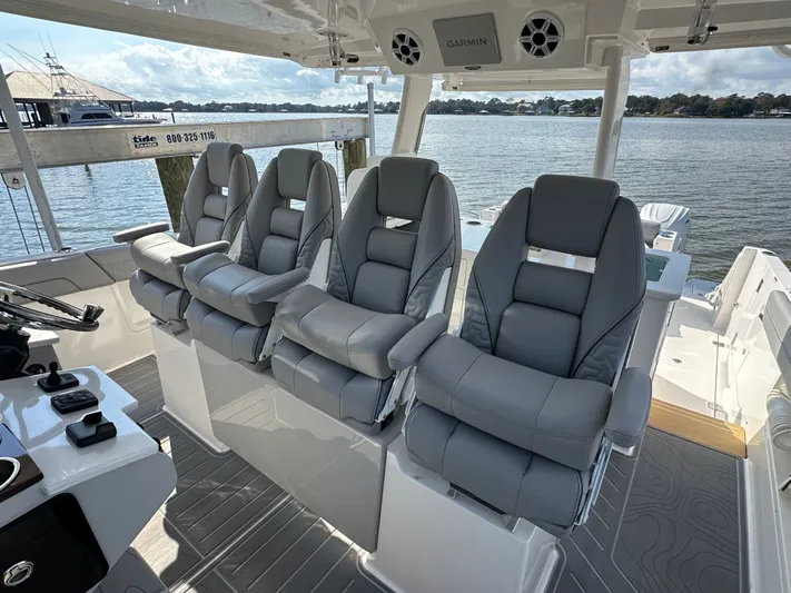  Yacht Photos Pics Luxurious seating on 2026 Regal 38 SAV boat with waterfront view.