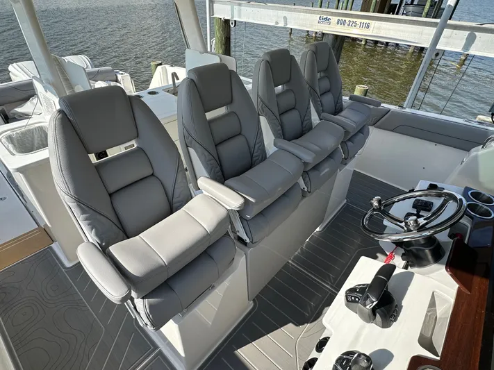  Yacht Photos Pics Luxurious seating and helm of 2026 Regal 38 SAV boat, docked by the water.