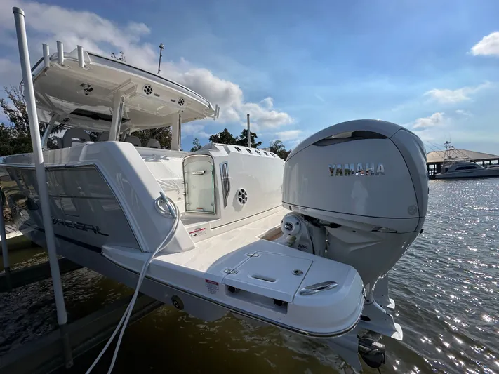  Yacht Photos Pics 2026 Regal 38 SAV boat with Yamaha engine docked by the water.