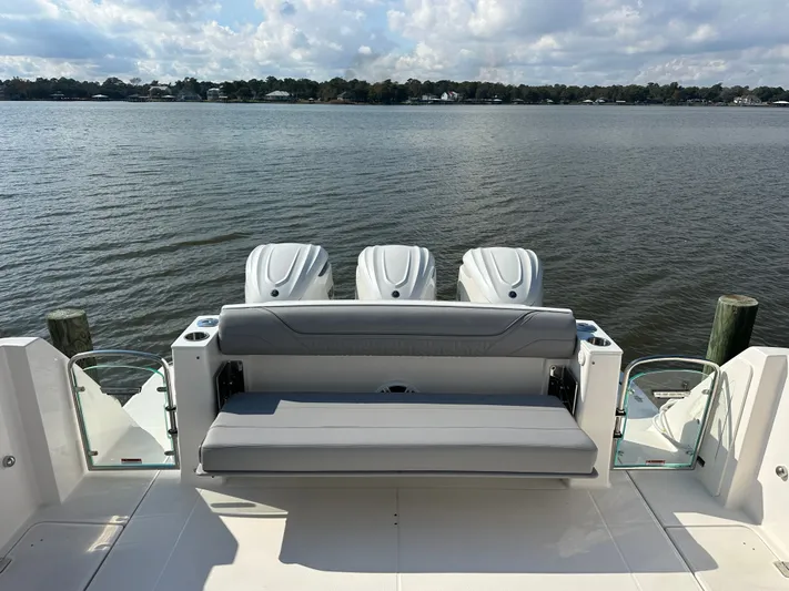  Yacht Photos Pics 2026 Regal 38 SAV boat with triple engines, rear seating, and scenic water view.