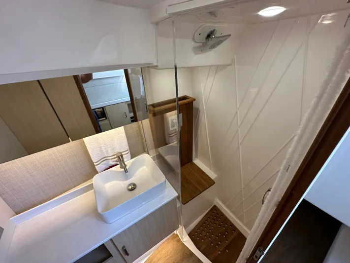  Yacht Photos Pics Luxurious bathroom interior of 2026 Regal 38 SAV yacht with modern sink and shower.