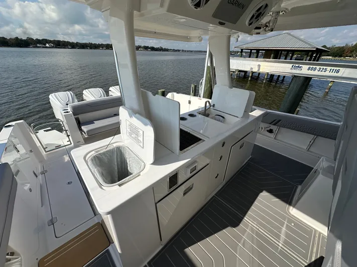  Yacht Photos Pics 2026 Regal 38 SAV boat interior with modern kitchen and seating area by the water.