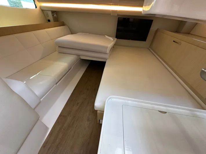  Yacht Photos Pics Luxurious interior of 2026 Regal 38 SAV yacht with modern seating and wood flooring.