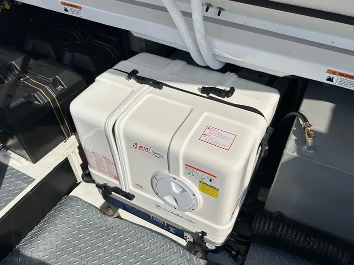  Yacht Photos Pics Generator compartment in a 2026 Regal 38 SAV boat, featuring a compact design.