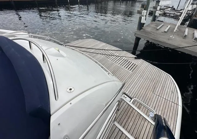 Interim Yacht Photos Pics Sunseeker 75 Predator 2002 yacht docked at marina, view of stern and swim platform.