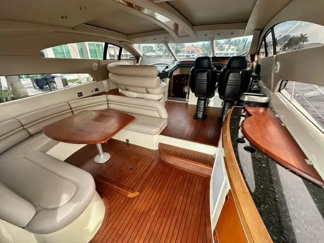 Interim Yacht Photos Pics Luxurious interior of a 2002 Sunseeker 75 Predator yacht with leather seating and wooden flooring.