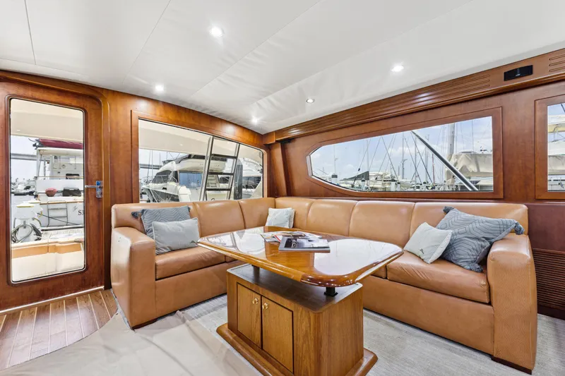 Deal Maker Yacht Photos Pics Luxurious interior of 2012 Bertram Custom Sportfish yacht with leather seating and wooden accents.