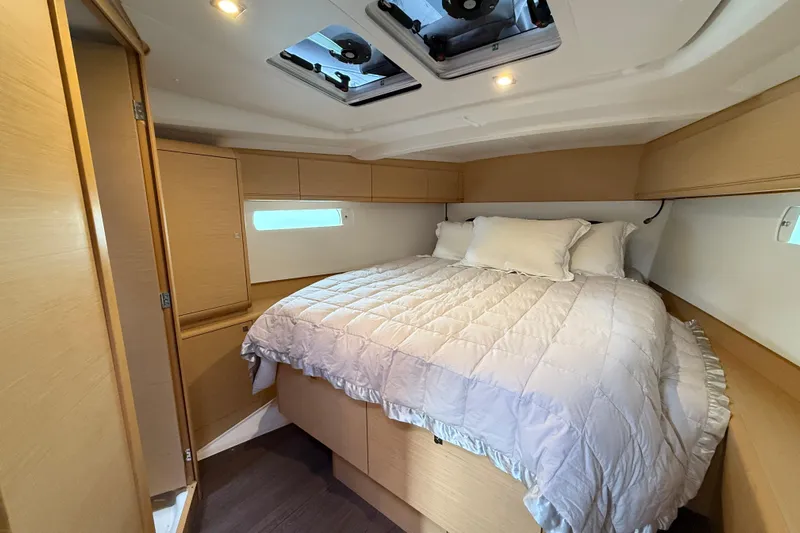 Shaboom Yacht Photos Pics Cozy cabin interior of 2017 Jeanneau Sun Odyssey 479 yacht with comfortable bedding.