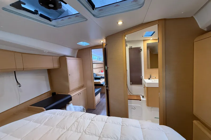 Shaboom Yacht Photos Pics Interior of 2017 Jeanneau Sun Odyssey 479 yacht, featuring cozy cabin and modern bathroom.