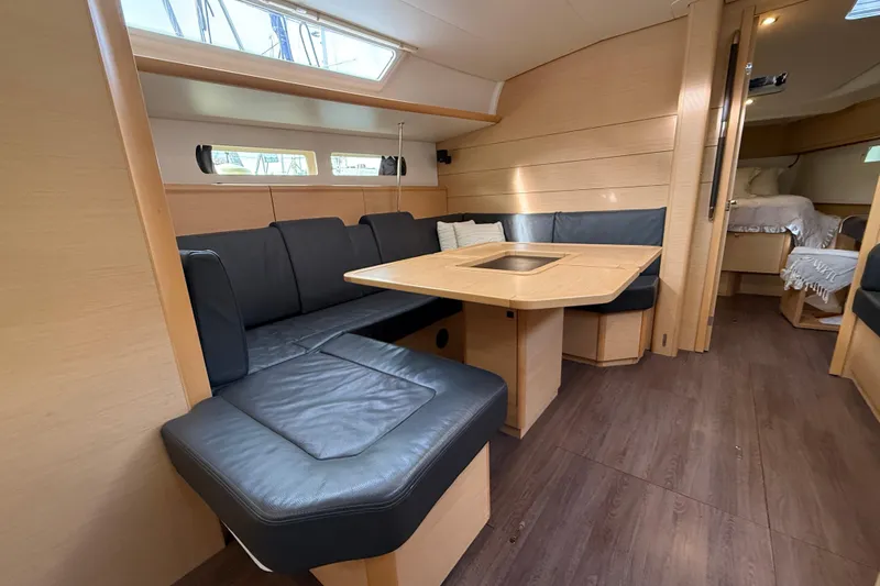 Shaboom Yacht Photos Pics Interior of 2017 Jeanneau Sun Odyssey 479 yacht with modern seating and dining area.