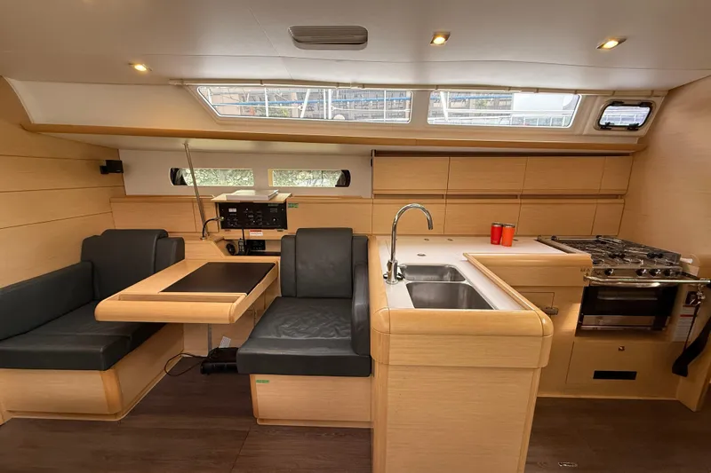 Shaboom Yacht Photos Pics Interior of 2017 Jeanneau Sun Odyssey 479 yacht with modern kitchen and seating area.