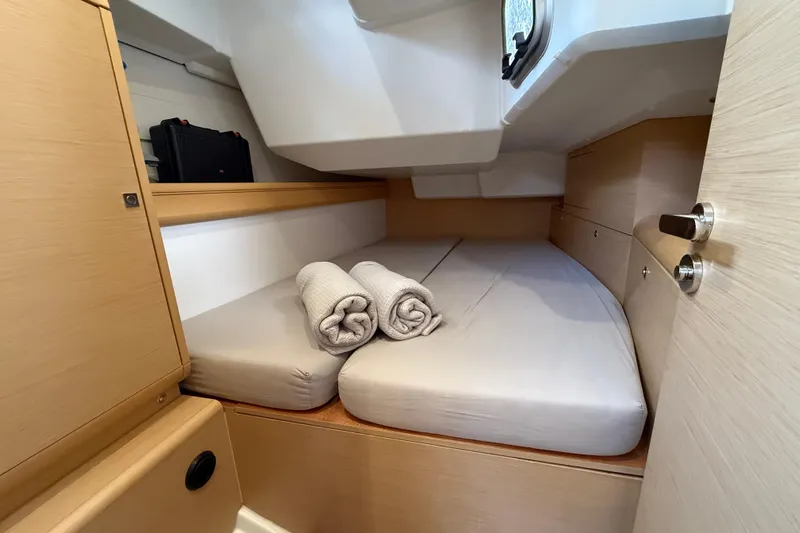 Shaboom Yacht Photos Pics Cozy cabin interior of 2017 Jeanneau Sun Odyssey 479 with neatly arranged bedding.