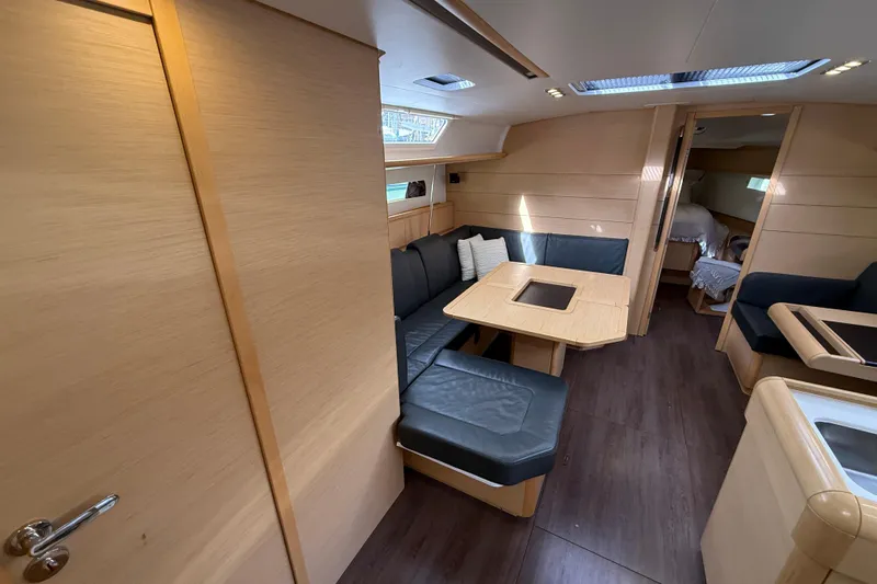 Shaboom Yacht Photos Pics Interior of 2017 Jeanneau Sun Odyssey 479 yacht with modern seating and dining area.
