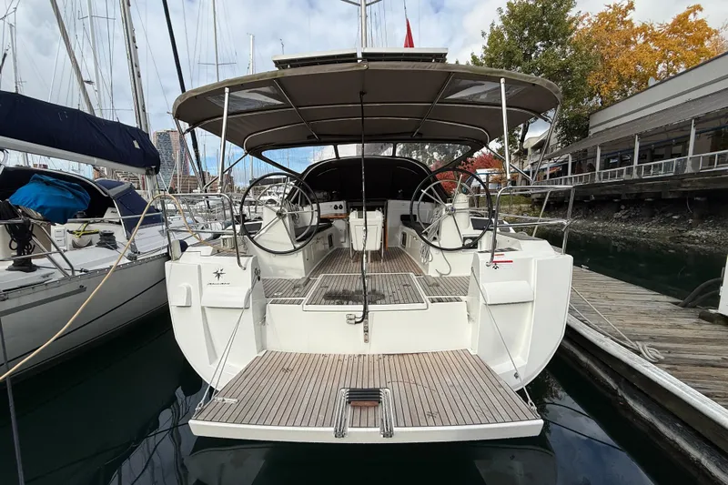 Shaboom Yacht Photos Pics 2017 Jeanneau Sun Odyssey 479 sailboat docked, showcasing dual steering wheels and spacious deck.