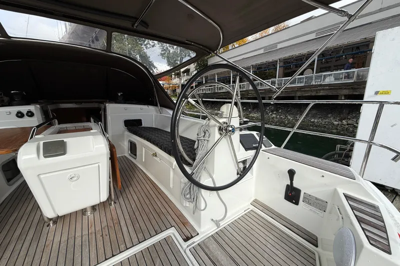 Shaboom Yacht Photos Pics Cockpit of 2017 Jeanneau Sun Odyssey 479 sailboat with steering wheel and seating.