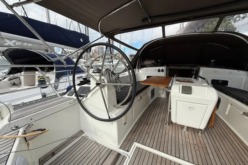 Shaboom Yacht Photos Pics 2017 Jeanneau Sun Odyssey 479 yacht cockpit with steering wheel and seating area.