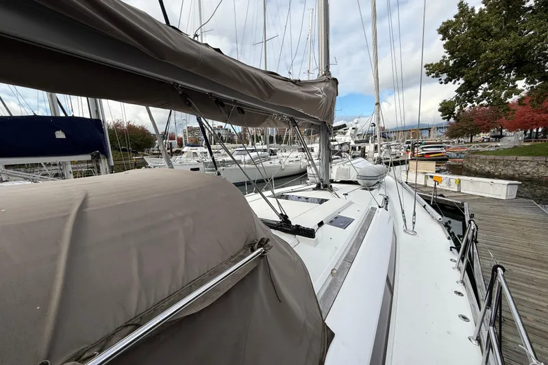 Shaboom Yacht Photos Pics 2017 Jeanneau Sun Odyssey 479 sailboat docked at marina, surrounded by other boats.