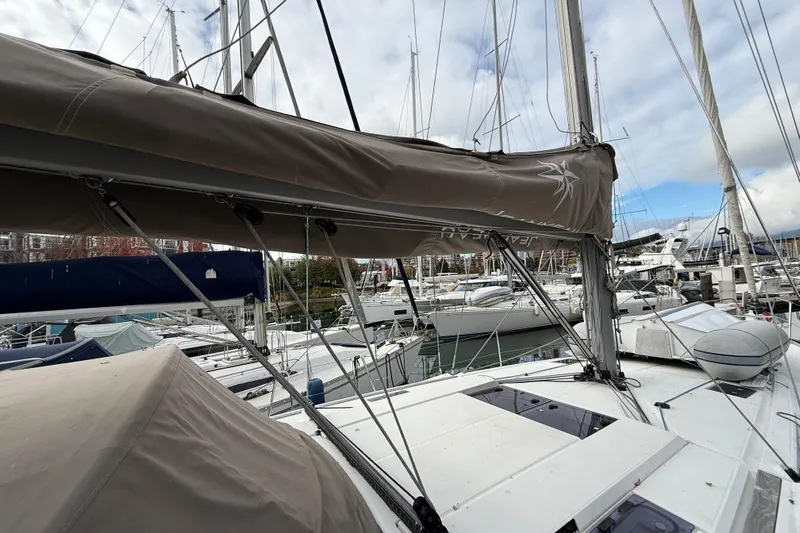 Shaboom Yacht Photos Pics 2017 Jeanneau Sun Odyssey 479 sailboat docked in a marina, surrounded by other boats.