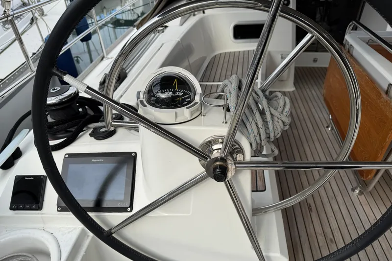 Shaboom Yacht Photos Pics Steering wheel and compass on 2017 Jeanneau Sun Odyssey 479 sailboat deck.