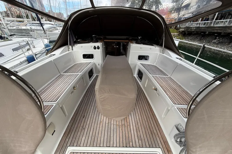 Shaboom Yacht Photos Pics 2017 Jeanneau Sun Odyssey 479 yacht cockpit with teak flooring and covered helm.